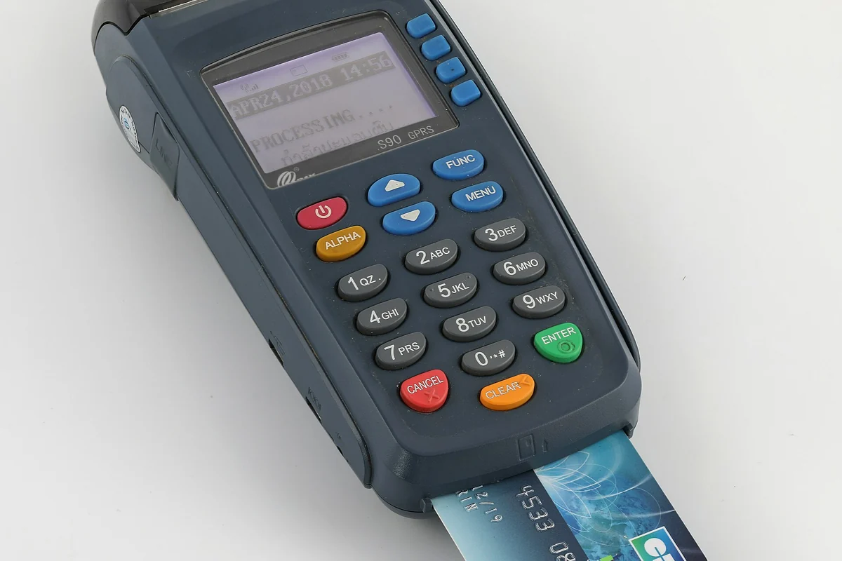 A card being used at a payment terminal in an everyday setting